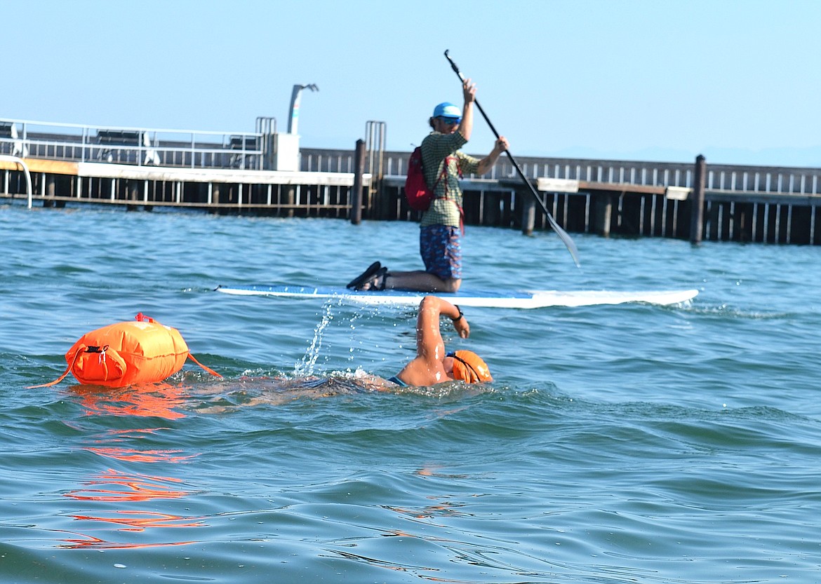 Long-distance swimmer Rachel Wanderscheid and Levi Rajnowski on SUP embark on Saturday's Poker Paddle. (Kristi Niemeyer/Leader)