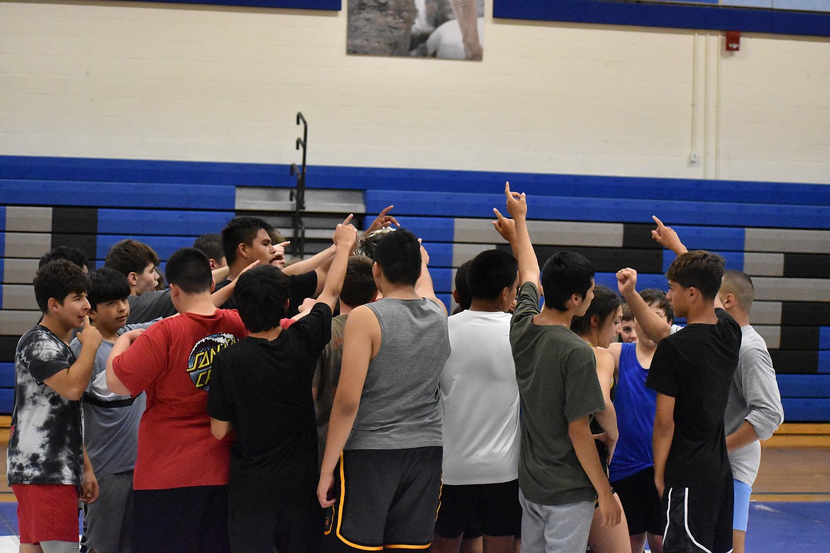 Campers at the Warden Wrestling Camp group together to end the first session on Friday morning.