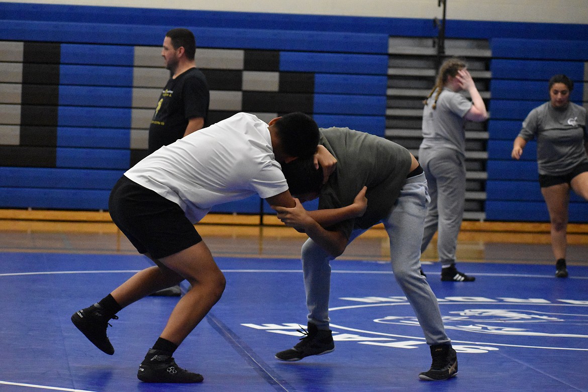 Two wrestlers at the Warden Wrestling Camp work on hand-fighting techniques on Friday morning.