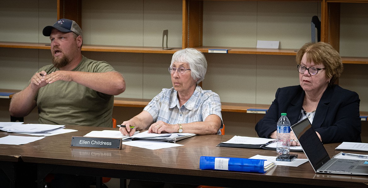 Plains School Board trustees Beau French, Ellen Childress and superintendent Dr. Kathleen Walsh discuss proposed activity pass fee changes. (Tracy Scott/Valley Press)
