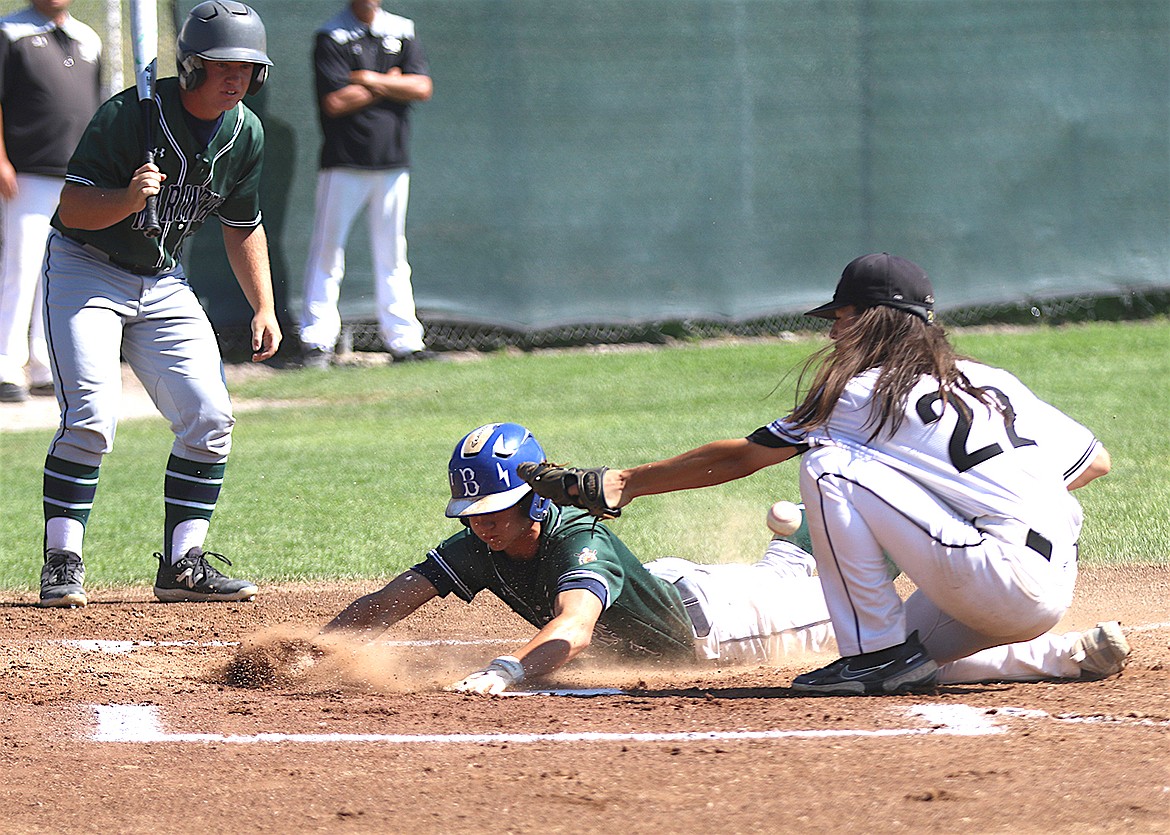 Cole Wadsworth slides into home base during Saturday's Mission Valley Mariners game against the Glacier Twins. (Bob Gunderson photo)