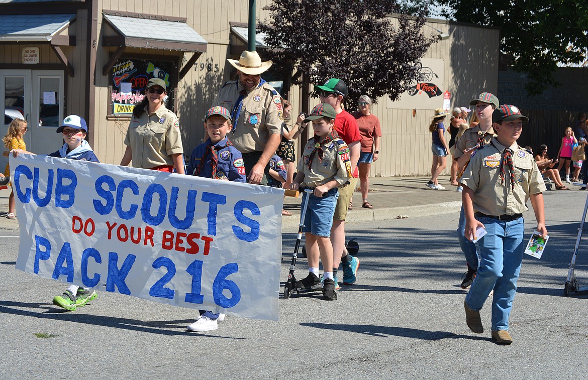 Cub Scouts Troop 216 hold up a banner with their group name and the mantra "do your best" during the Rathdrum Days Parade.