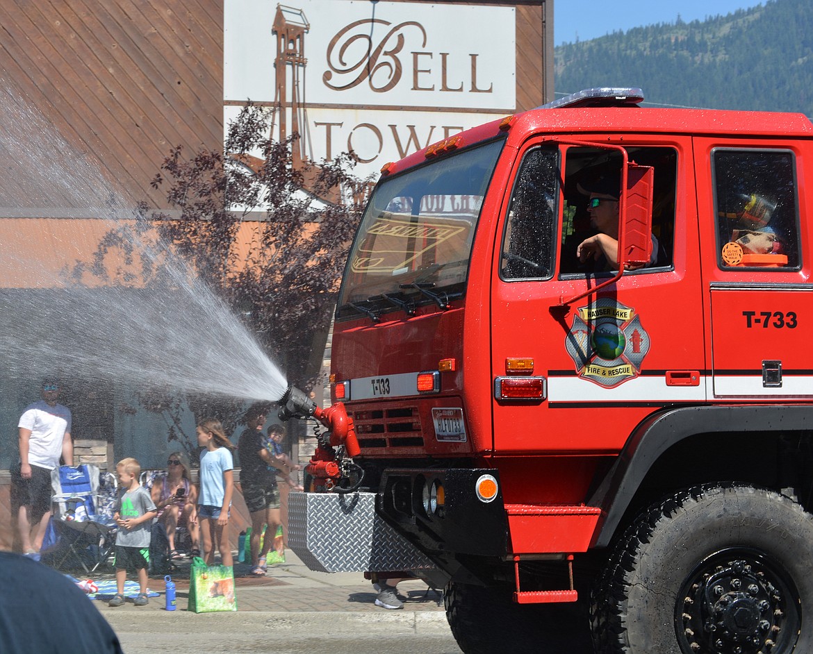 A House Lake fire truck sprays spectators at the Rathdrum Days Parade.