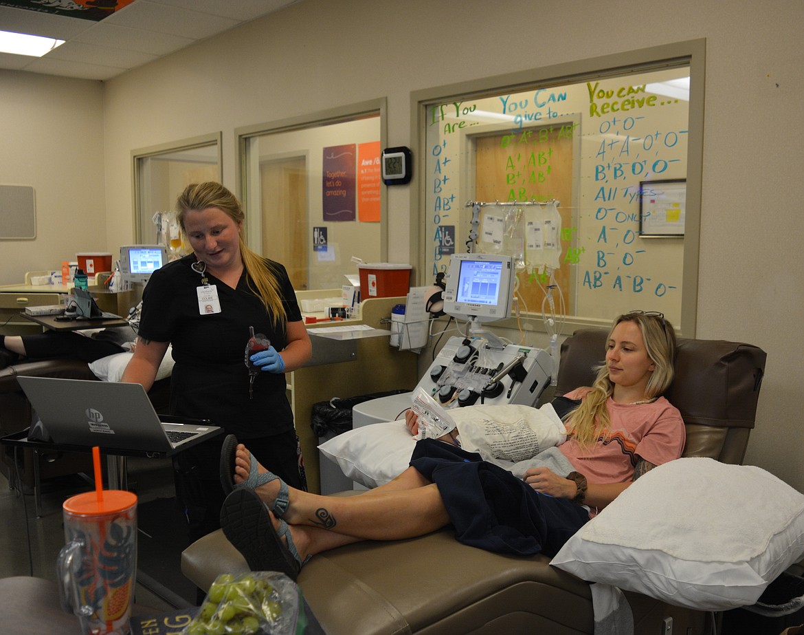 Phlebotomist Colbie Hayes prepares to obtain platelets from Zoie Cloutier Monday at Vitalant. Blood supplies often dip during the summer months, when the need for donations often goes up, causing emergency need like the one that northern Idaho is currently undergoing.