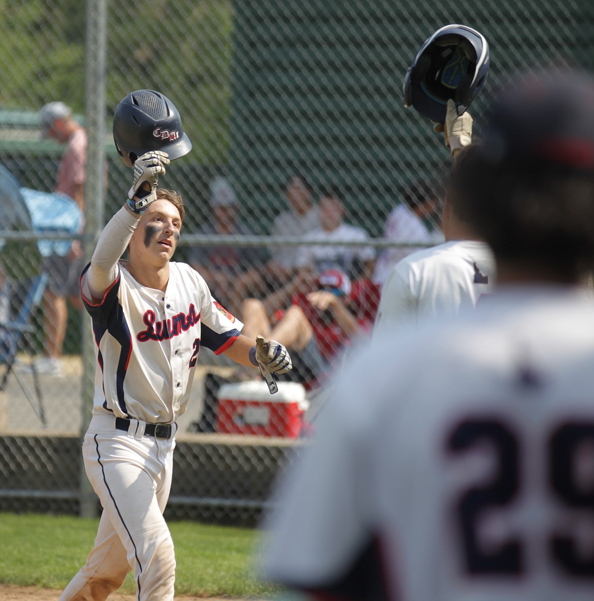 JASON ELLIOTT/Press
Coeur d'Alene Lumbermen catcher Joe DuCoeur is congratulated after hitting a solo home run during the bottom of the sixth inning of Monday's state AA American Legion baseball tournament game at Thorco Field.