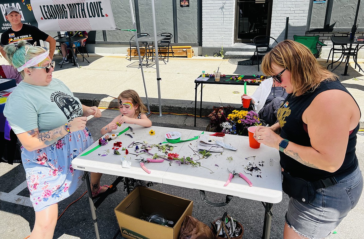 Local florist Sarah Murphy (pictured on the right) had a table set up at Silver Valley Pride where attendees could play with flowers and build small arrangements of their own.