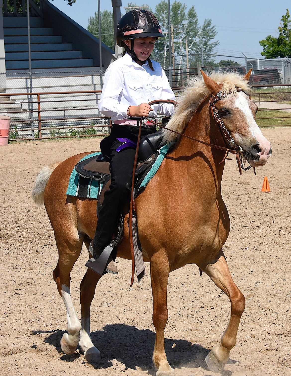 Saddle Mountain 4-H member Abrianna Mitchell rides Caspian back to the trailer after receiving a grand champion ribbon. This is Abrianna's first show riding, and she was all smiles. (Berl Tiskus/Leader)