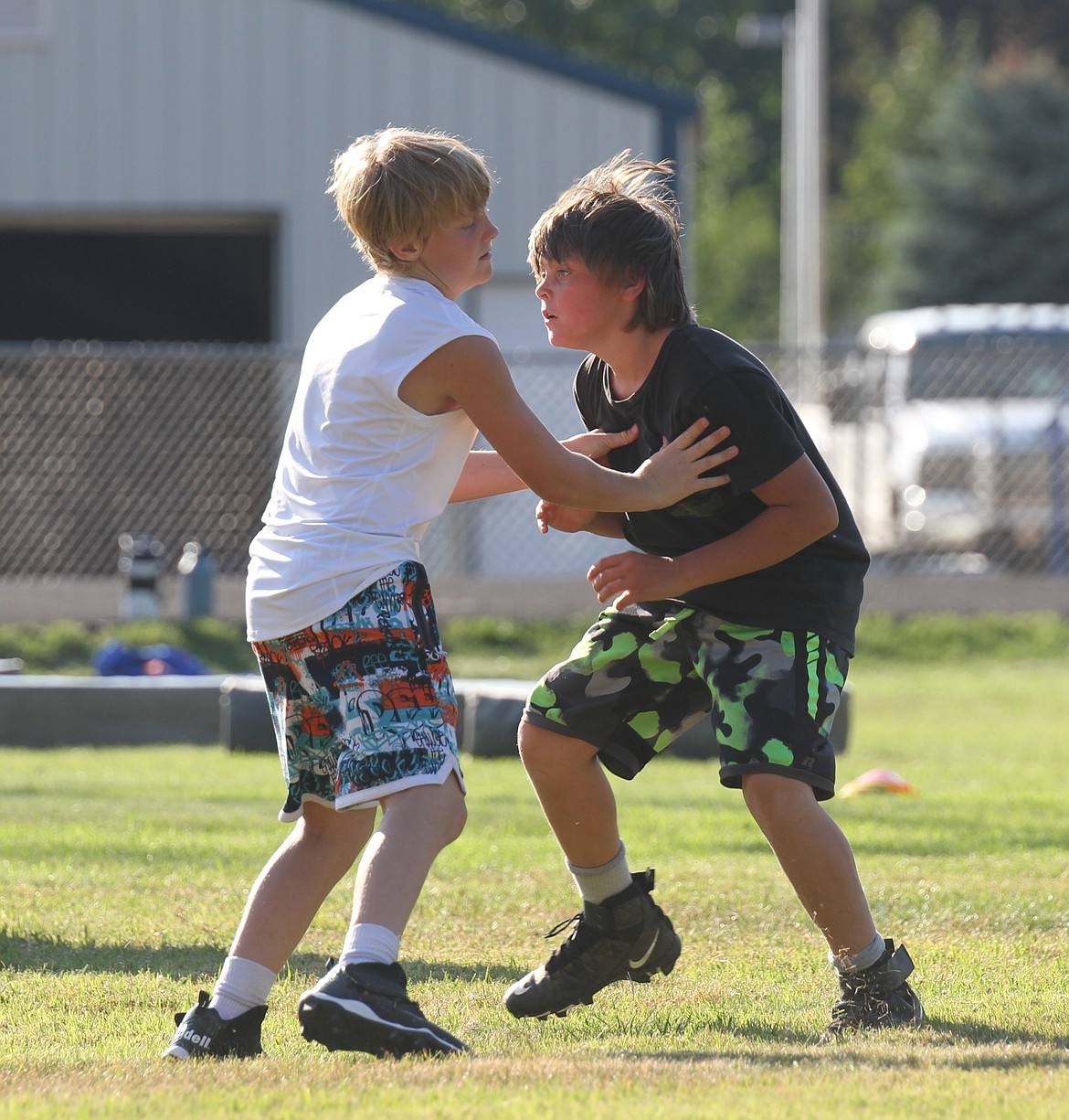 Two athletes block each other in a lineman drill on Friday.