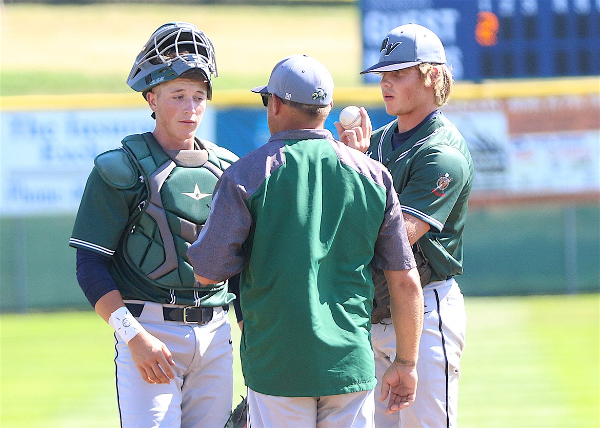 Mission Valley Mariners catcher Espn Fisher, coach Drew DuMont and pitcher Dawson DuMont consult on the mound Saturday during the American Legion divisional tournament in Polson. (Bob Gunderson photo)