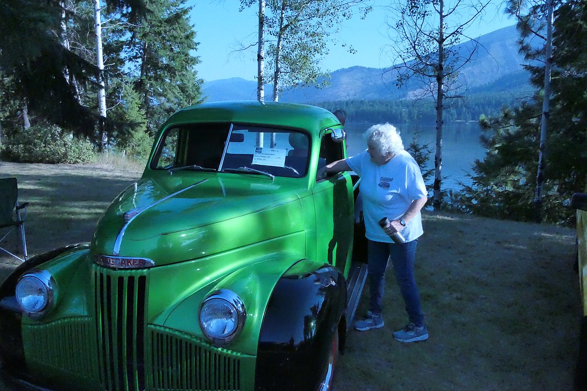 Nancy McDowell, from Rollins, puts the finishing pre-shows touches on she and her husband's 1947 Studebaker pickup that was on display this Saturday at the Cool Summer Nights car show in Trout Lake. (Chuck Bandel/VP-MI)