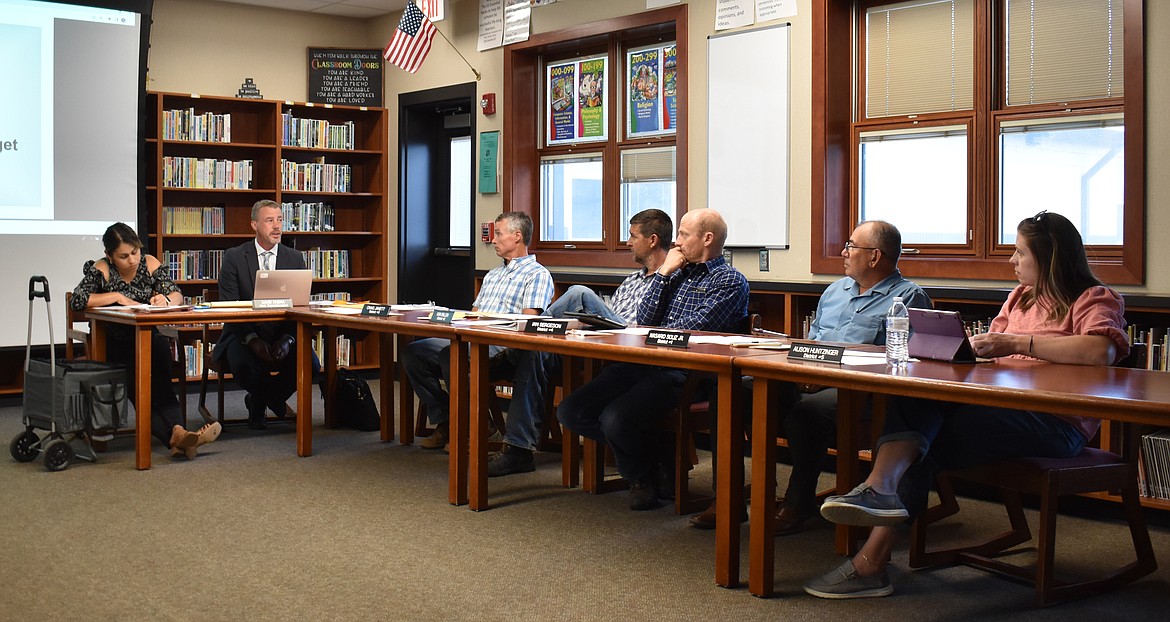 Royal School District Assistant Superintendent David Andra, flanked by Executive Assistant Arendra Deras, right, addresses the Royal School Board at its monthly meeting Monday. From left: Board President Craig Janett and board members Dan Miller, Ian Bergeson, Nasario Solis Jr. and Alison Huntzinger.