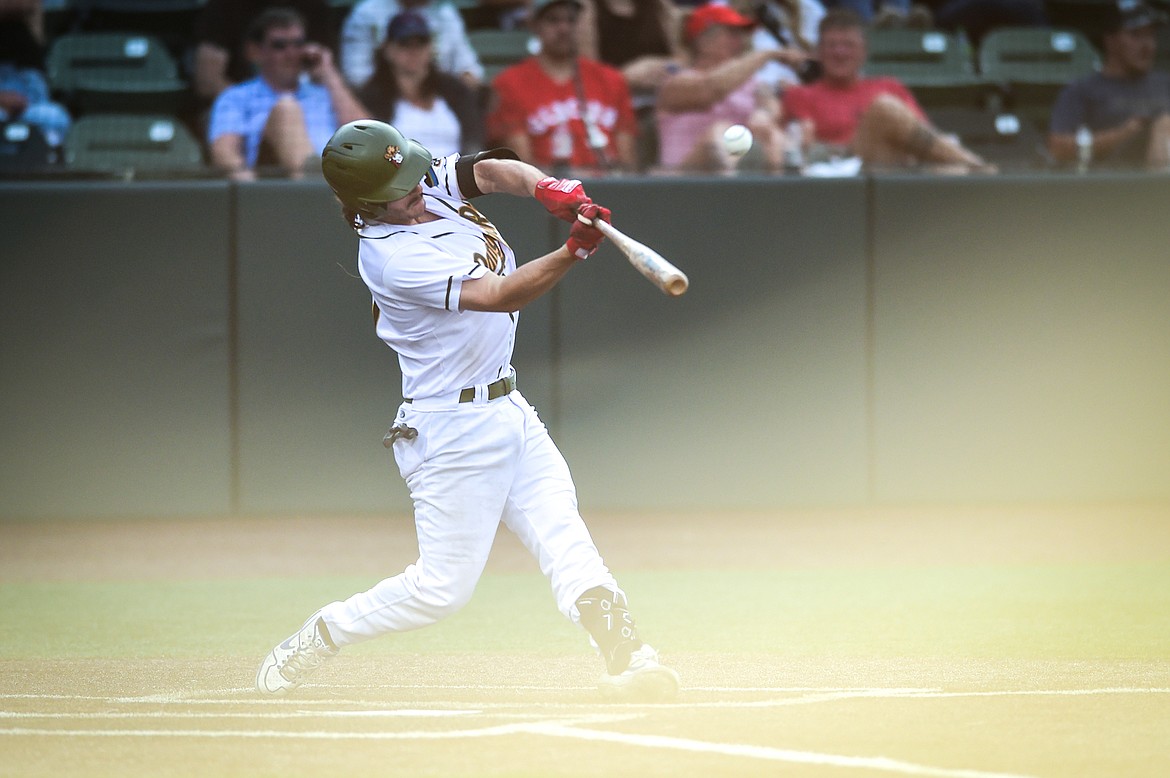 Glacier's Matt Clayton (11) connects on a solo home run in the fourth inning against the Missoula Paddleheads at Glacier Bank Park on Tuesday, July 25. (Casey Kreider/Daily Inter Lake)