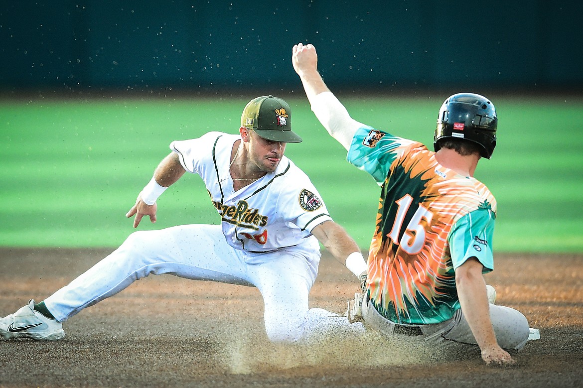 Glacier shortstop Gabe Howell (10) puts the tag on Missoula's Thomas DeBonville (15) to complete a double play after a force out at first base in the seventh inning against the Missoula Paddleheads at Glacier Bank Park on Tuesday, July 25. (Casey Kreider/Daily Inter Lake)