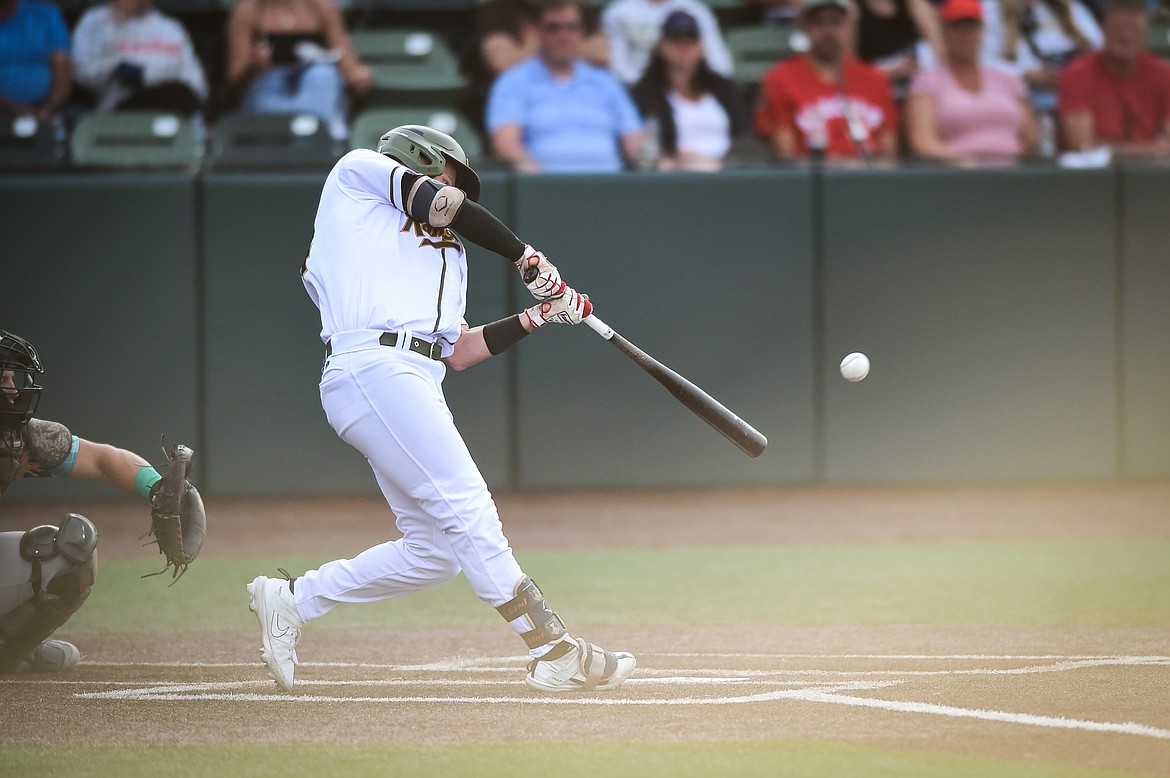 Glacier's Jackson Raper (14) connects on an RBI double in the third inning against the Missoula Paddleheads at Glacier Bank Park on Tuesday, July 25. (Casey Kreider/Daily Inter Lake)