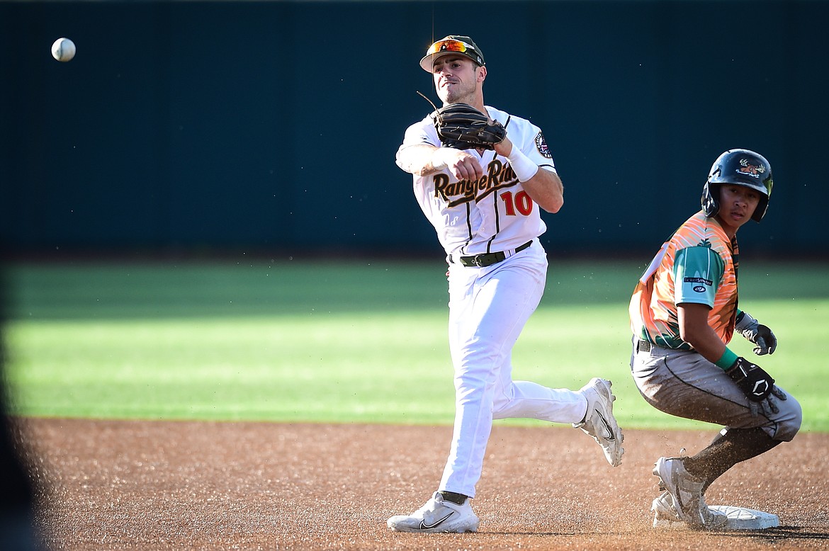 Glacier shortstop Gabe Howell (10) tries to turn a double play in the second inning against the Missoula Paddleheads at Glacier Bank Park on Tuesday, July 25. (Casey Kreider/Daily Inter Lake)