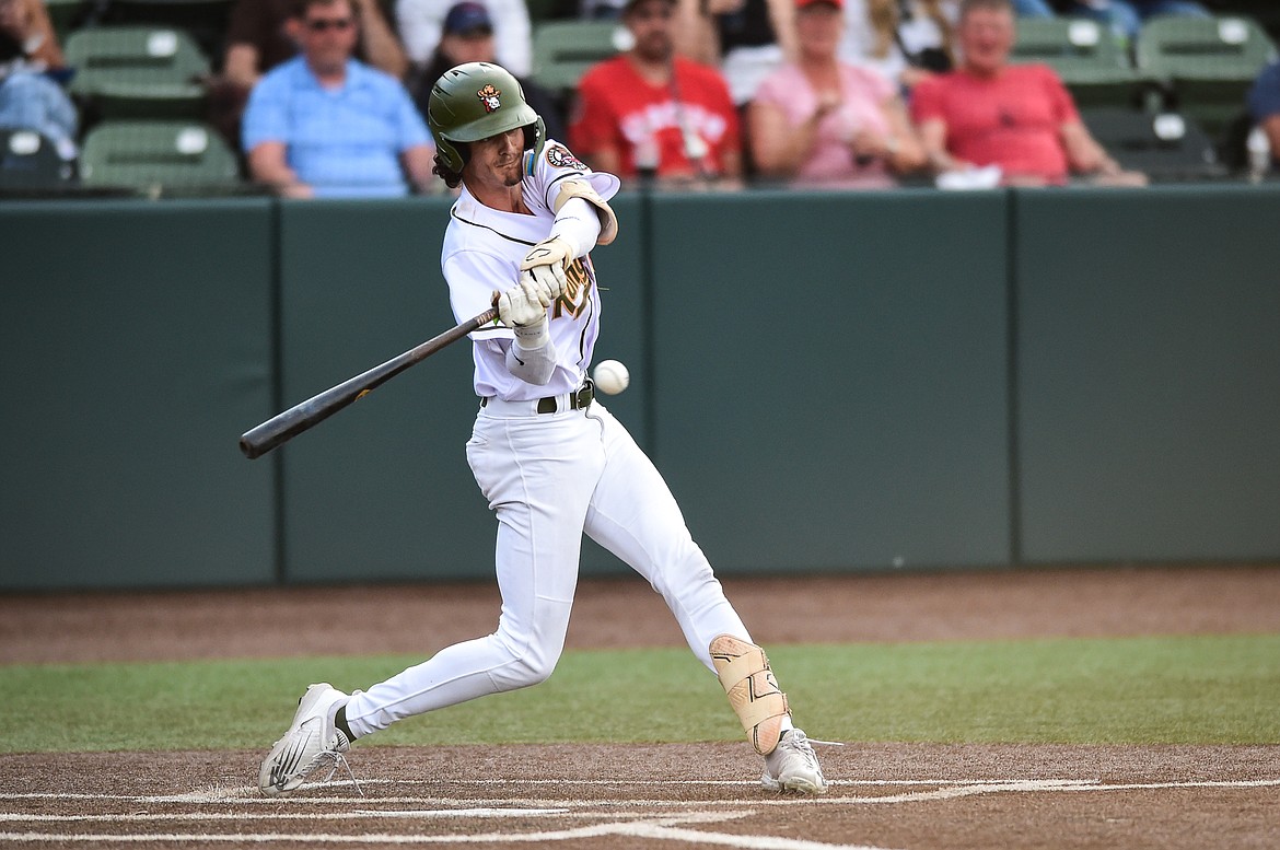 Glacier's Mason Dinesen (23) connects on an RBI single in the third inning against the Missoula Paddleheads at Glacier Bank Park on Tuesday, July 25. (Casey Kreider/Daily Inter Lake)