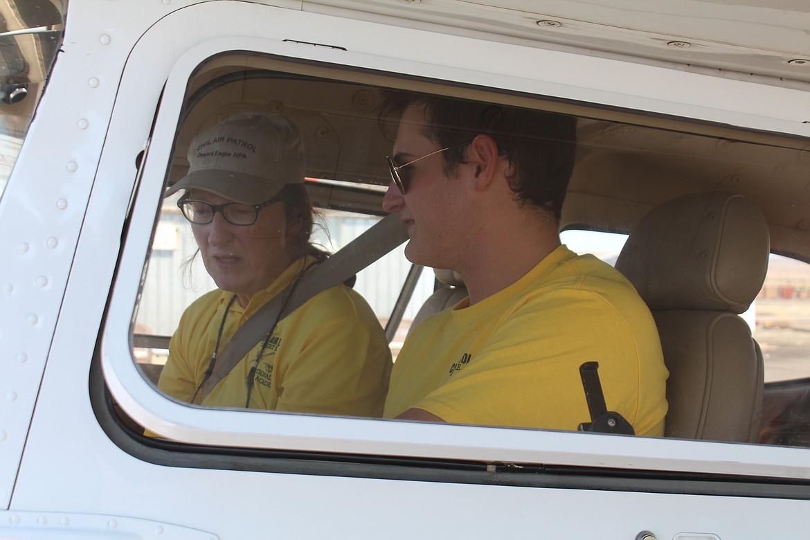 Student pilot AJ Silianoff, right, and instructor Karin Hollenbach, left, go over the post-flight checklist during the National Flight Academy sponsored by the Civil Air Patrol.