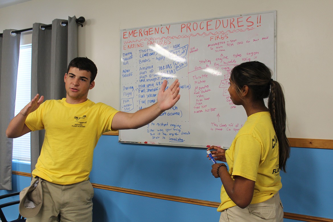 Mitchell Natale, left, and Mia Mayachar, right, quiz each other on emergency procedures in ground school classes. The two are students at the Civil Air Patrol National Flight Academy at the Ephrata Municipal Airport,