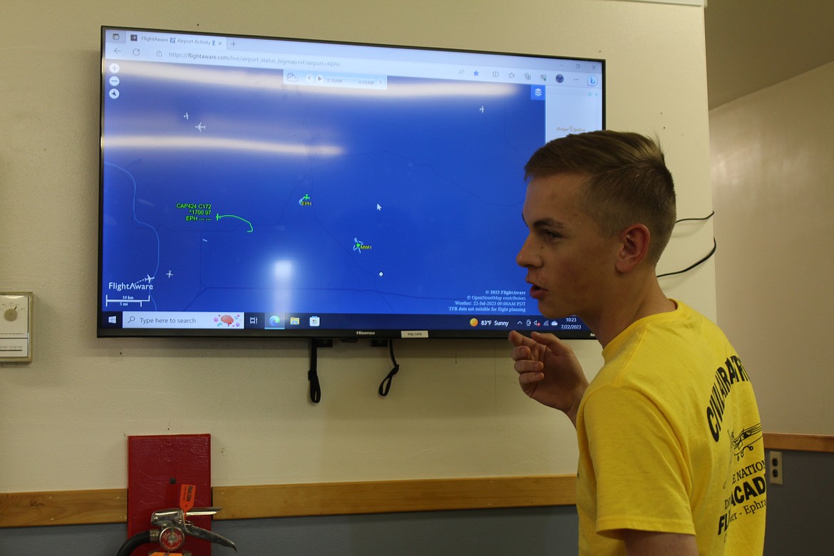 Garrett Johnson checks the status of the planes in the air at the National Flight Academy.