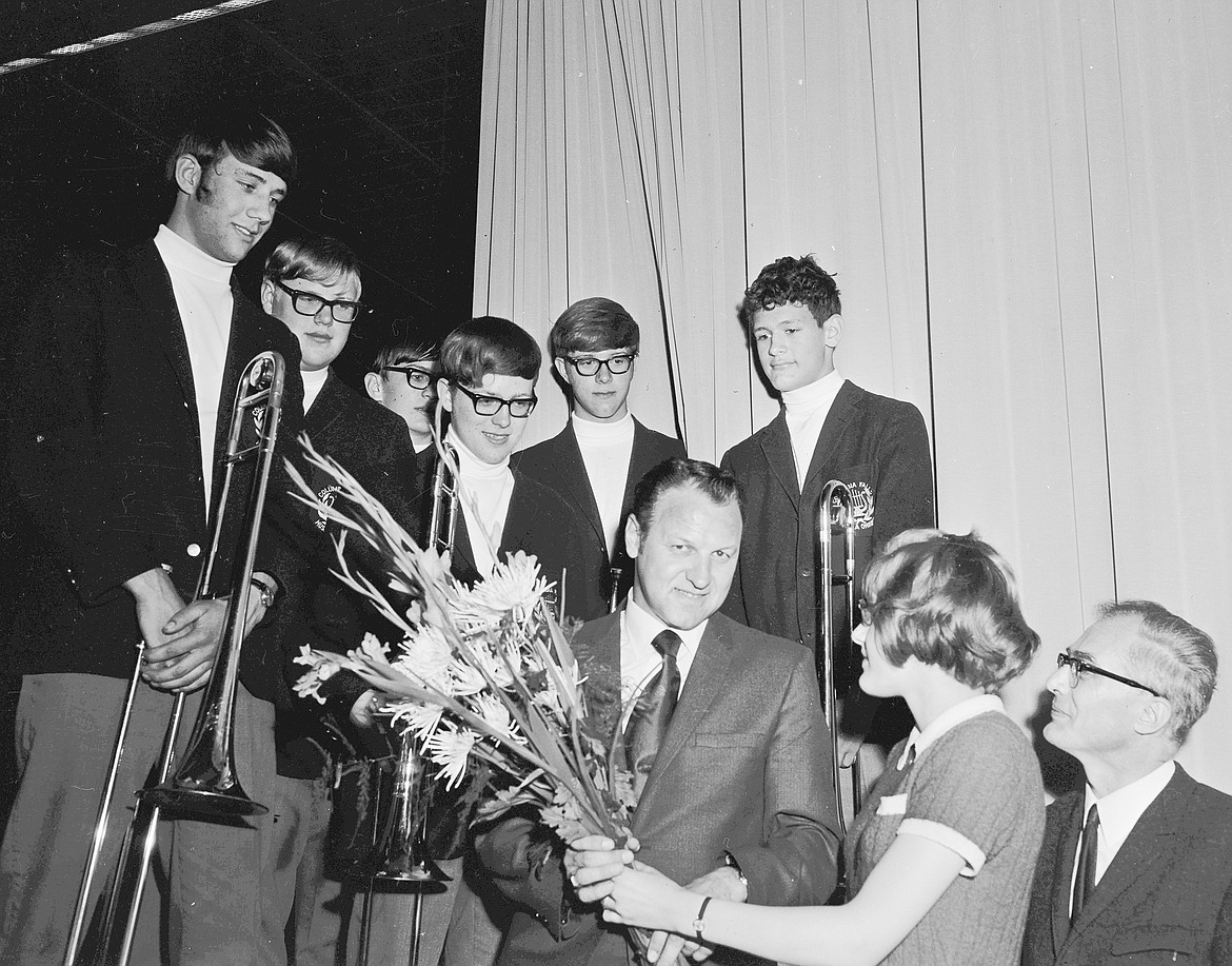 Columbia Falls High Band Director Don Lawrence was presented a bouquet by a German student after a concert in Germany in 1970. At right is Herr Reinhold Schaper, headmaster. From left are some of the Columbians: Virgil Larson, Clinton Hoerner, Roger Newman, Harold Riley, Jerry Knutson and Dave Thorkelson. (Mel Ruder photo)