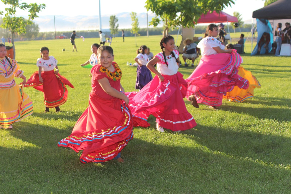 Children show off their dance moves during a performance at the health fair and movie night in Mattawa Friday.