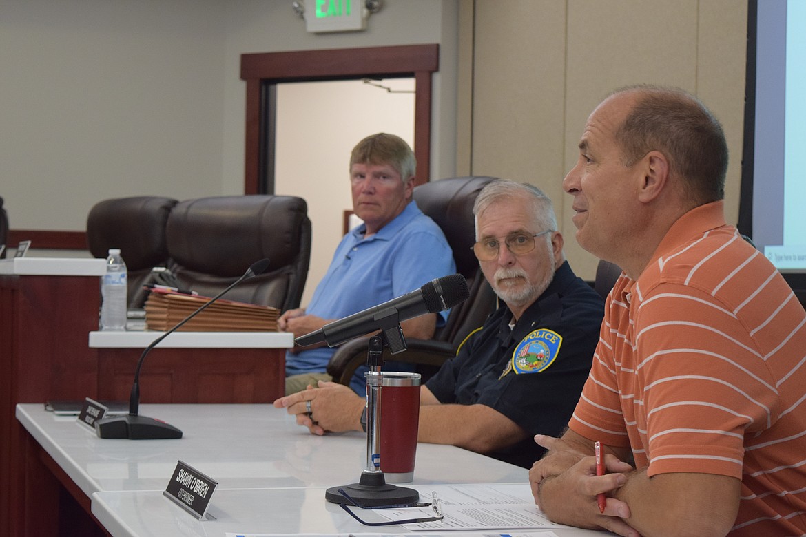 Othello City Engineer Shawn O’Brien (right) speaks to council members about the costs of the city's contract for the installation of new playground equipment in Lions Park, which the council approved unanimously at Monday's regular meeting.