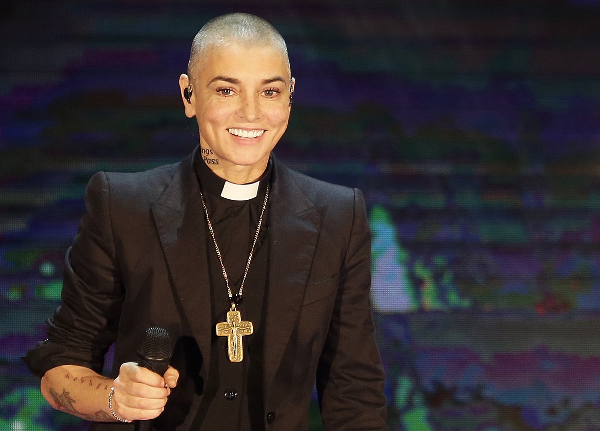 Irish singer Sinead O'Connor performs during the Italian State RAI TV program "Che Tempo che Fa", in Milan, Italy on Oct. 5, 2014. O’Connor, the gifted Irish singer-songwriter who became a superstar in her mid-20s but was known as much for her private struggles and provocative actions as for her fierce and expressive music, has died at 56. The singer's family issued a statement reported Wednesday by the BBC and RTE. (AP Photo/Antonio Calanni, File)