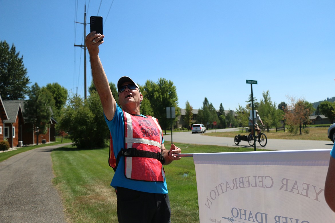 A participant in a historical walk through Dover Saturday takes a selfie to mark the occasion. The walk commemorated the community's centennial and the barging of more than 50 homes and the Dover Community Church from Laclede to Dover.