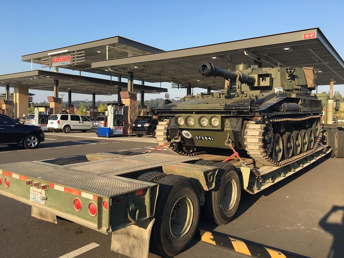 Julia and Jim Hossack, of Rathdrum, refuel their self-propelled gun at a gas station. The couple have been fixing up demilitarized vehicles for about 20 years and moved to the area about three years ago.