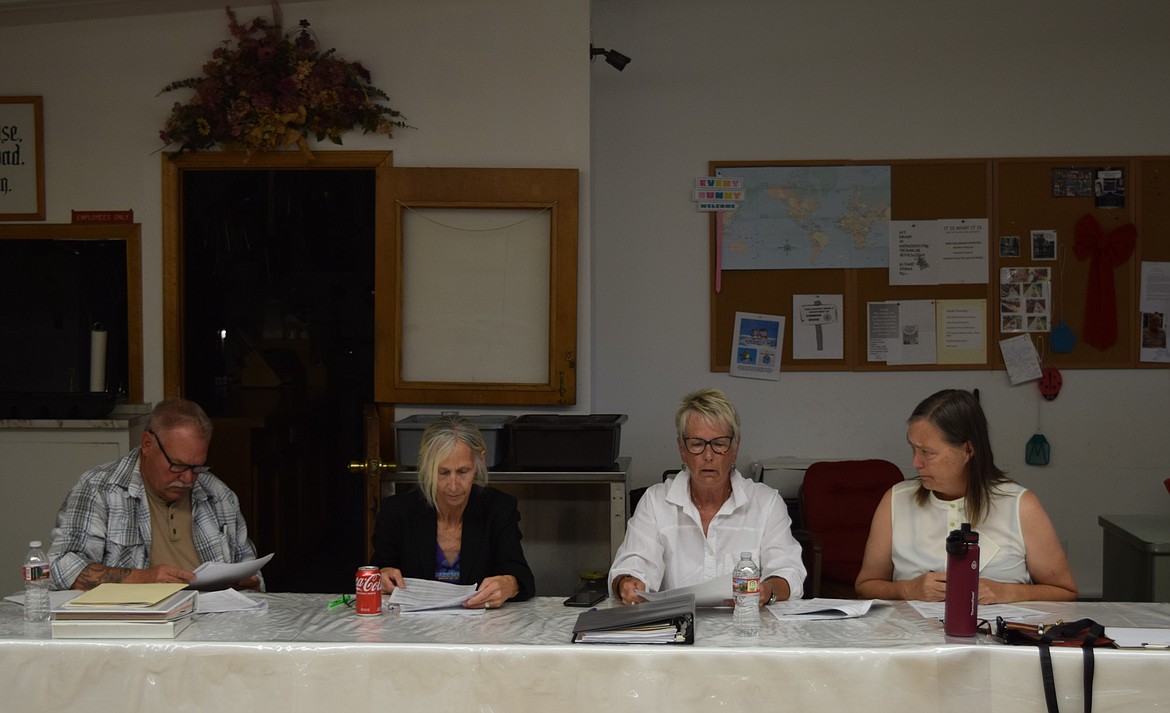 Soap Lake City Council members look over budget reports during the budget workshop from several smaller city funds while Fiscal Specialist Cheryl Brandt leads them through the document and shows them how to read the forms and spot errors.