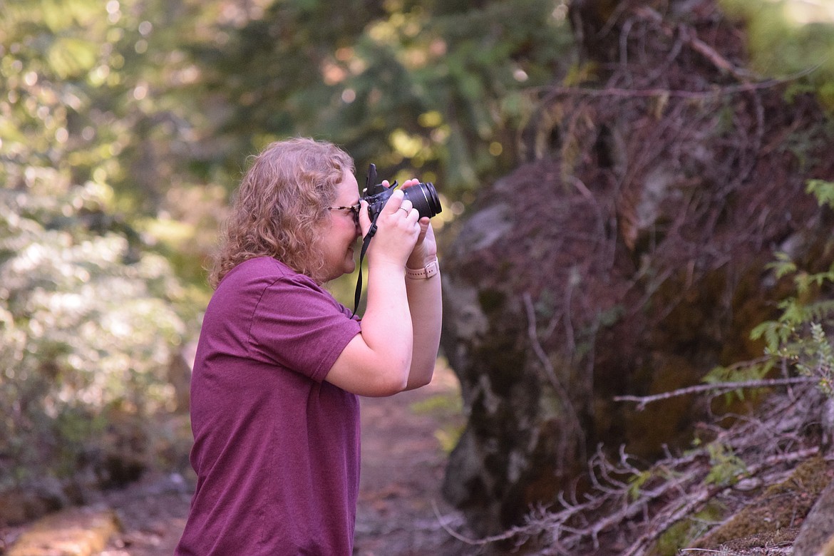 The Bygone Byways Trailhead site offers nature lovers an opportunity to put their cameras to good use taking photos of flora and fauna. Above, Brandee Miller takes photos of some of the scenery along the hiking path.