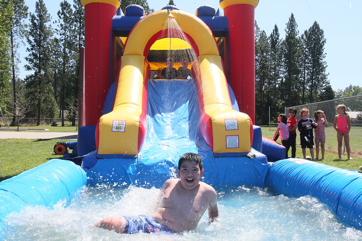 Hendrix Sauno-Chacon, 10, splashes down a water slide Thursday during the CDA Reads celebration and season closer at Fernan STEM Academy.