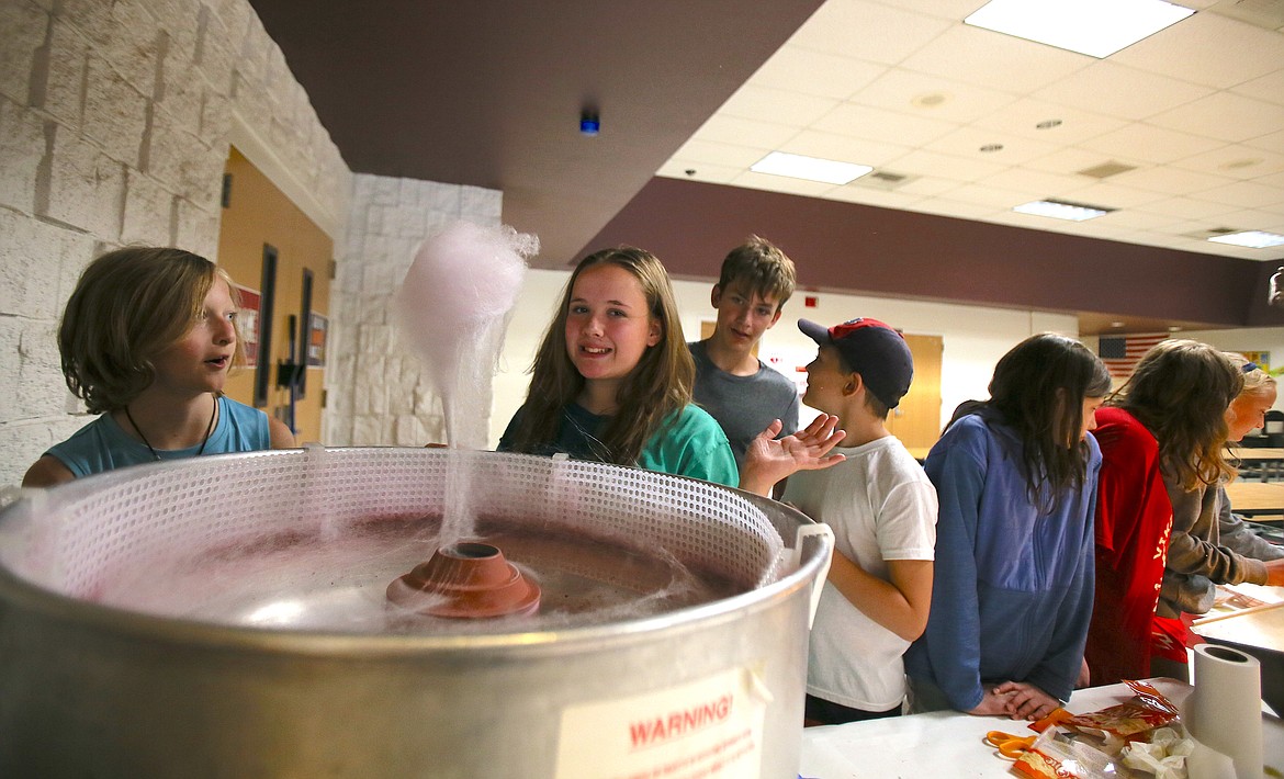 Incoming Coeur d'Alene High School freshman and CDA Reads volunteer Jewel Martin, 14, finishes spooling floss sugar around paper cones to make cotton candy Thursday during the last day of the 2023 CDA Reads program. This was Jewel's third summer volunteering as a mentor.