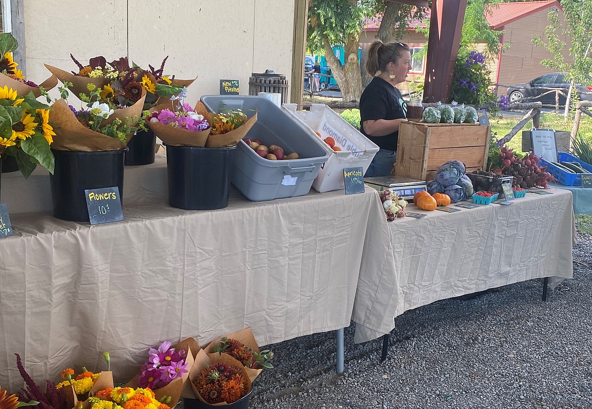 A vendor selling flowers and produce at Cloudview Farm’s 2022 Summer Sunflower Fest, which was the event’s first year. The event featured local vendors and activities and will do the same this year.