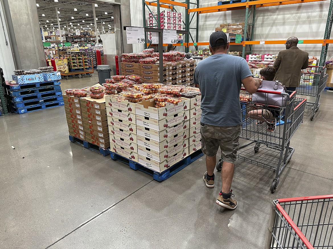 Shoppers peruse a display of Rainer cherries at a Costco warehouse Tuesday, July 11, 2023, in Sheridan, Colo. On Friday, The Commerce Department issues its June report on consumer spending. (AP Photo/David Zalubowski)