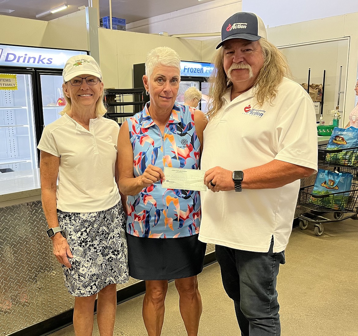 Coeur d'Alene Ladies 18-hole Golf Club presented a donation of $5,000 to the Community Action Partnership Coeur d'Alene Food Bank. The funds were raised June 24-25 during the annual Ladies' Weekender Golf Tournament at the Coeur d'Alene Golf Club. Tournament participants also donated nearly 500 pounds of food to the food bank. From left: Rhonda Schultz, treasurer; Vicki Moffat, tournament chairperson; and Darrell Rickard, food bank program manager.