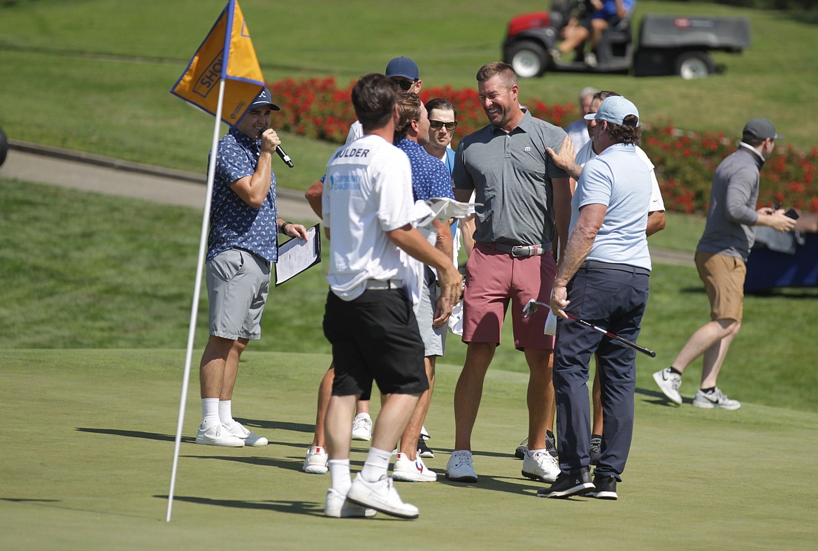 JASON ELLIOTT/Press
Former NHL player Brenden Morrow congratulates former MLB pitcher Mark Mulder following his win at The Showcase golf exhibition on Saturday at The Coeur d'Alene Resort Golf Course.