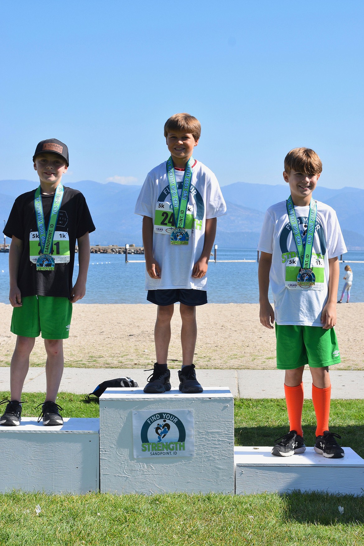 A trio of runners receive their awards at the first Find Your Strength 5K/1K Fun Run in 2022.