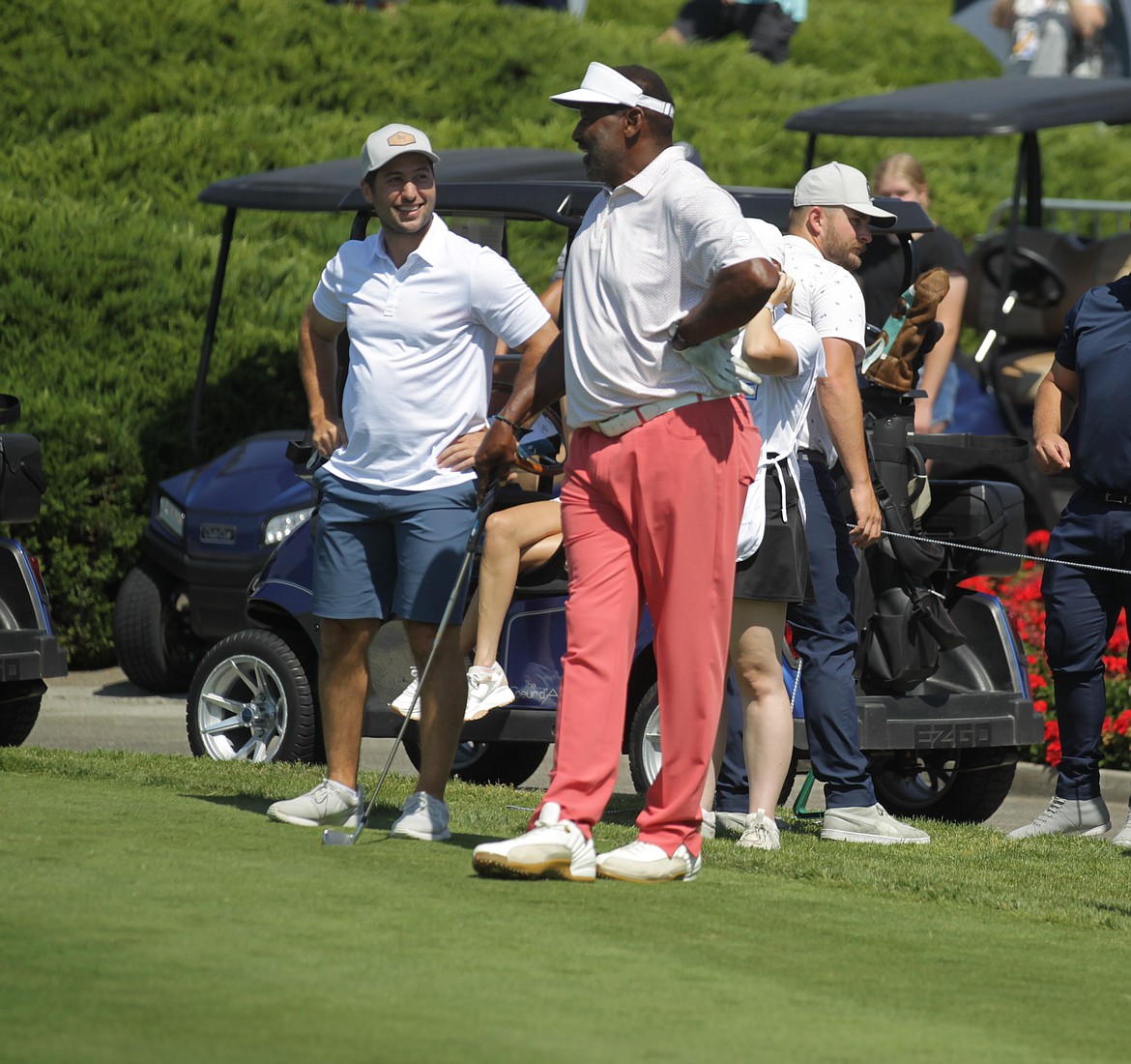 JASON ELLIOTT/Press
Former Spokane Chief and current Chicago Blackhawk center Tyler Johnson, left, and Super Bowl XX MVP of the Chicago Bears Richard Dent chat before teeing off on the Floating Green at The Coeur d'Alene Resort Golf Course during the ninth Showcase golf exhibition on Saturday.