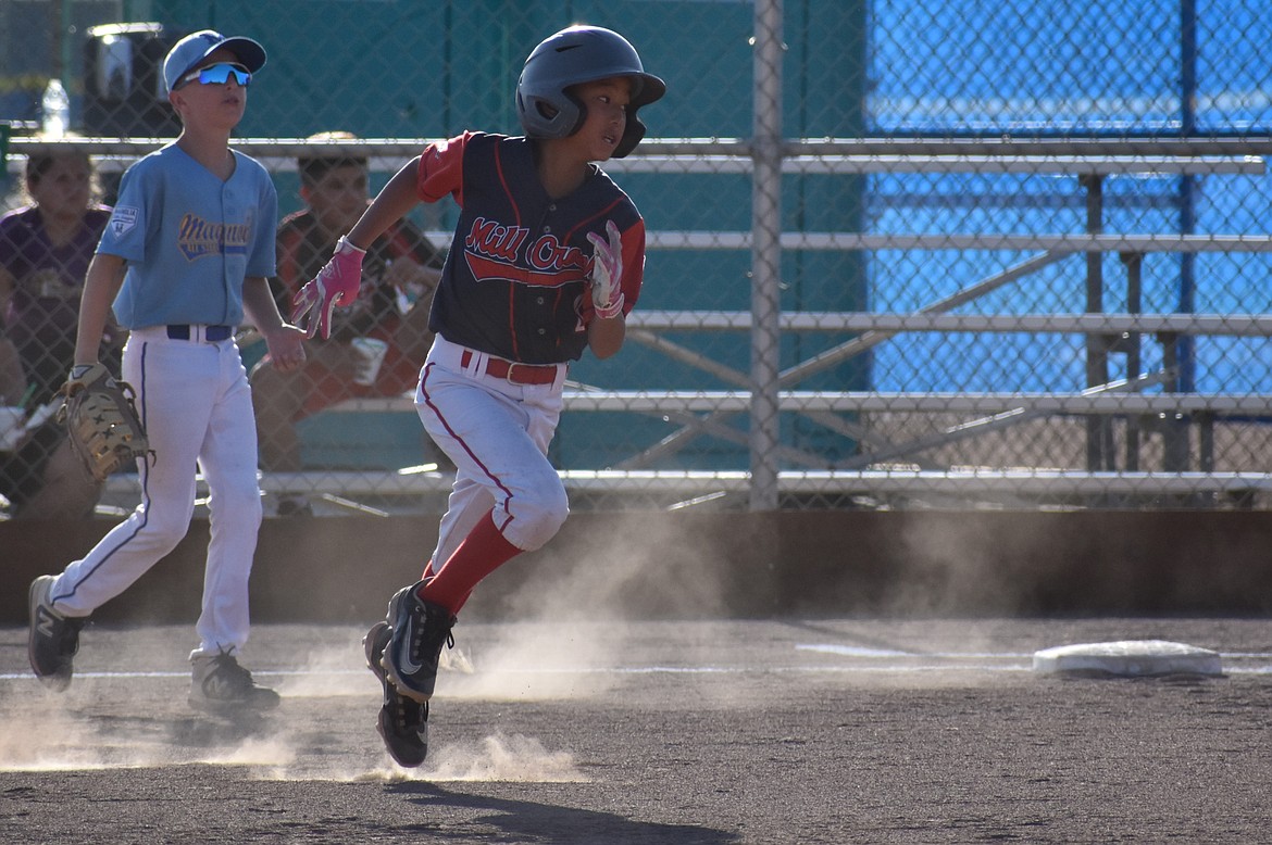 A Mill Creek base runner dashes toward second base in Friday’s consolation bracket final against Magnolia.