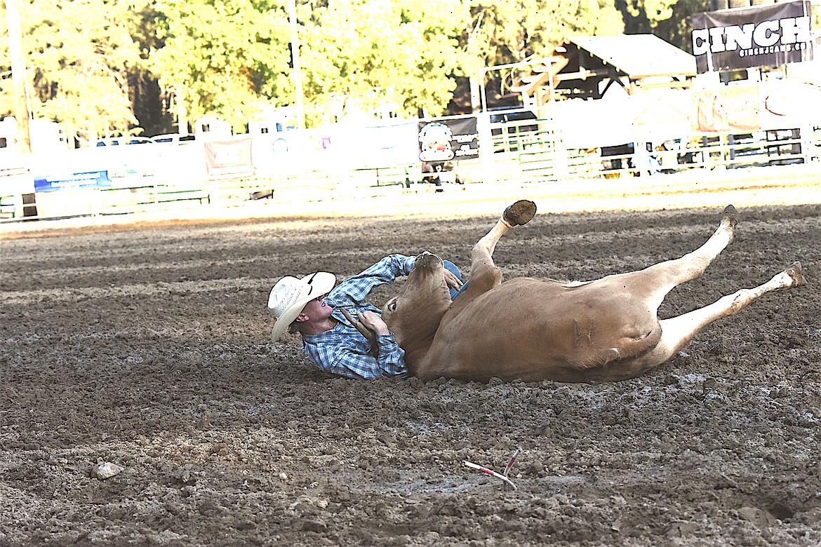 Soap Lake, Washington's Hank Sutton competes Saturday evening in the steer wrestling event at the Kootenai River Stampede. (Scott Shindledecker/The Western News)