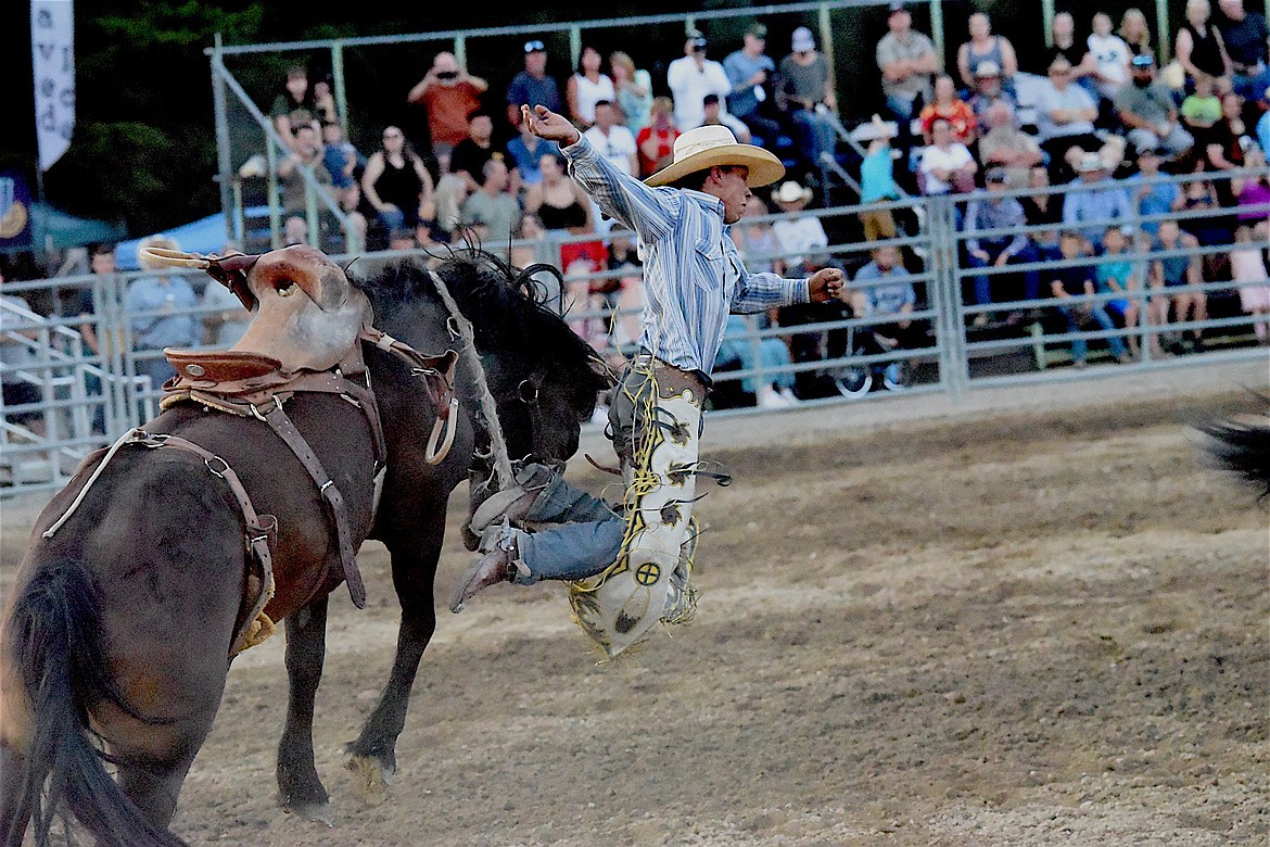 Busby's Nathaniel Justin Whiteman competes Friday evening in the saddle bronc event at the Kootenai River Stampede. (Scott Shindledecker/The Western News)