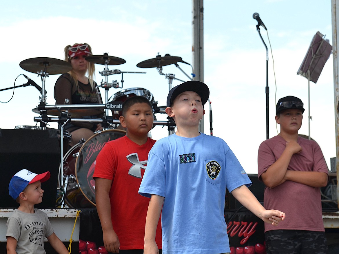 Contestant puckers up to spit his cherry pit in the 6-12 age category at the Cherry Pit Spitting Contest Saturday. (Kristi Niemeyer/Leader)