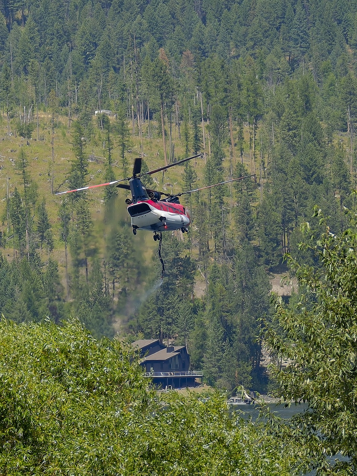 A type 1 firefighting helicopter flies over the North Lake wildfire on Saturday, July 29, on the north end of Whitefish Lake. (Joseph Raudabaugh photo)