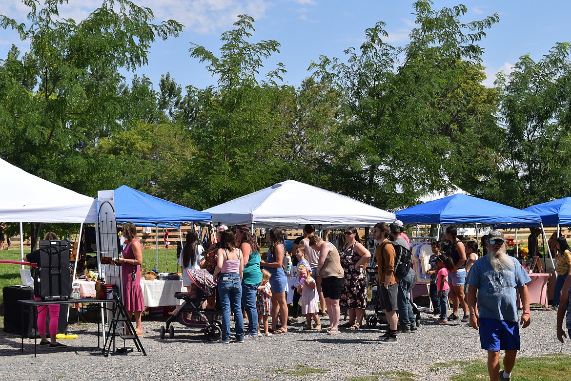 Members of the community browse local vendors selling their goods at Ephrata nonprofit Cloudview Farm’s 2nd annual Summer Sunflower Fest.