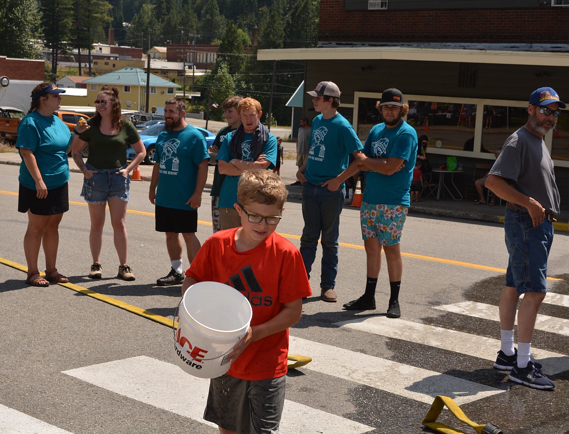 A child brings a bucket to be filled up from an open hydrant during the Mullan Fireman's Fun Festival as the adults get ready to compete in the Make-n-Break.

The two-day celebration hosts competitions for adults and kids as part of a fundraiser for the Mullan Volunteer Fire Department.