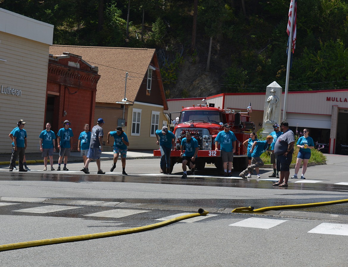 Competitors in the Make-n-Break race to assemble a fire hose, aim and knock over a target with water, and then disassemble the hose. The four-person team with the best time wins. The two-day celebration hosts competitions for adults and kids as part of a fundraiser for the Mullan Volunteer Fire Department.