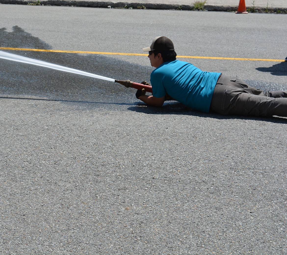 Competitors in the Make-n-Break race to assemble a fire hose, aim and knock over a target with water, and then disassemble the hose. The four-person team with the best time wins. The two-day celebration hosts competitions for adults and kids as part of a fundraiser for the Mullan Volunteer Fire Department.