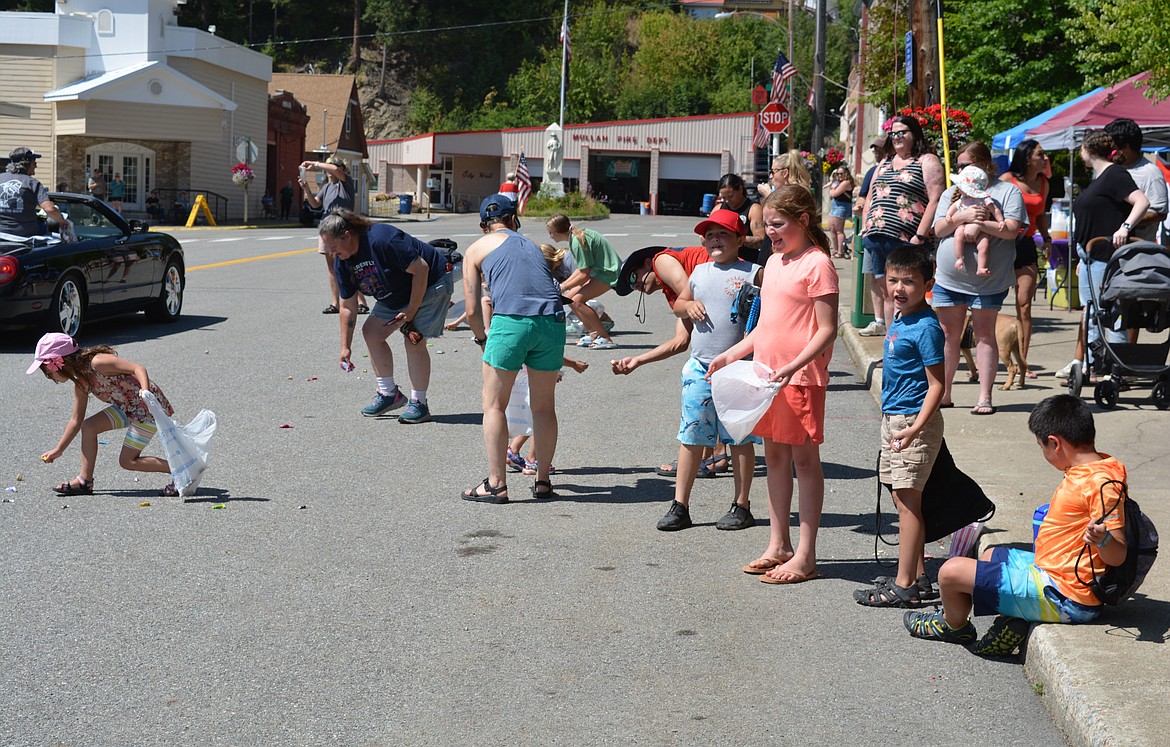 Natalynn Lane, 8, and other spectators line up to get candy during the parade Saturday at Mullan Fireman's Fun Festival. The two-day celebration hosts competitions for adults and kids as part of a fundraiser for the Mullan Volunteer Fire Department.