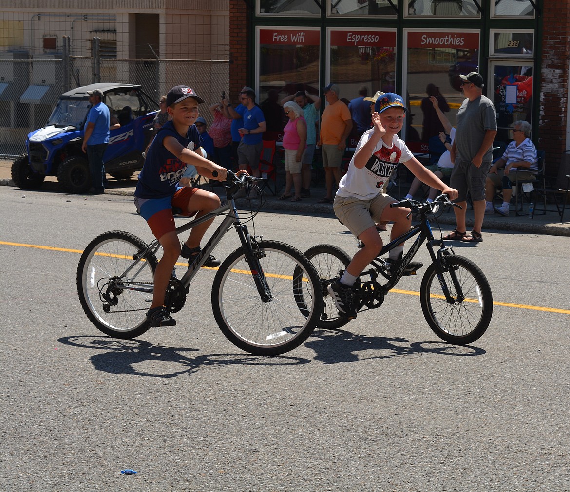 Kids bike in the parade during Mullan Fireman's Fun Festival Saturday. The two-day celebration hosts competitions for adults and kids as part of a fundraiser for the Mullan Volunteer Fire Department.